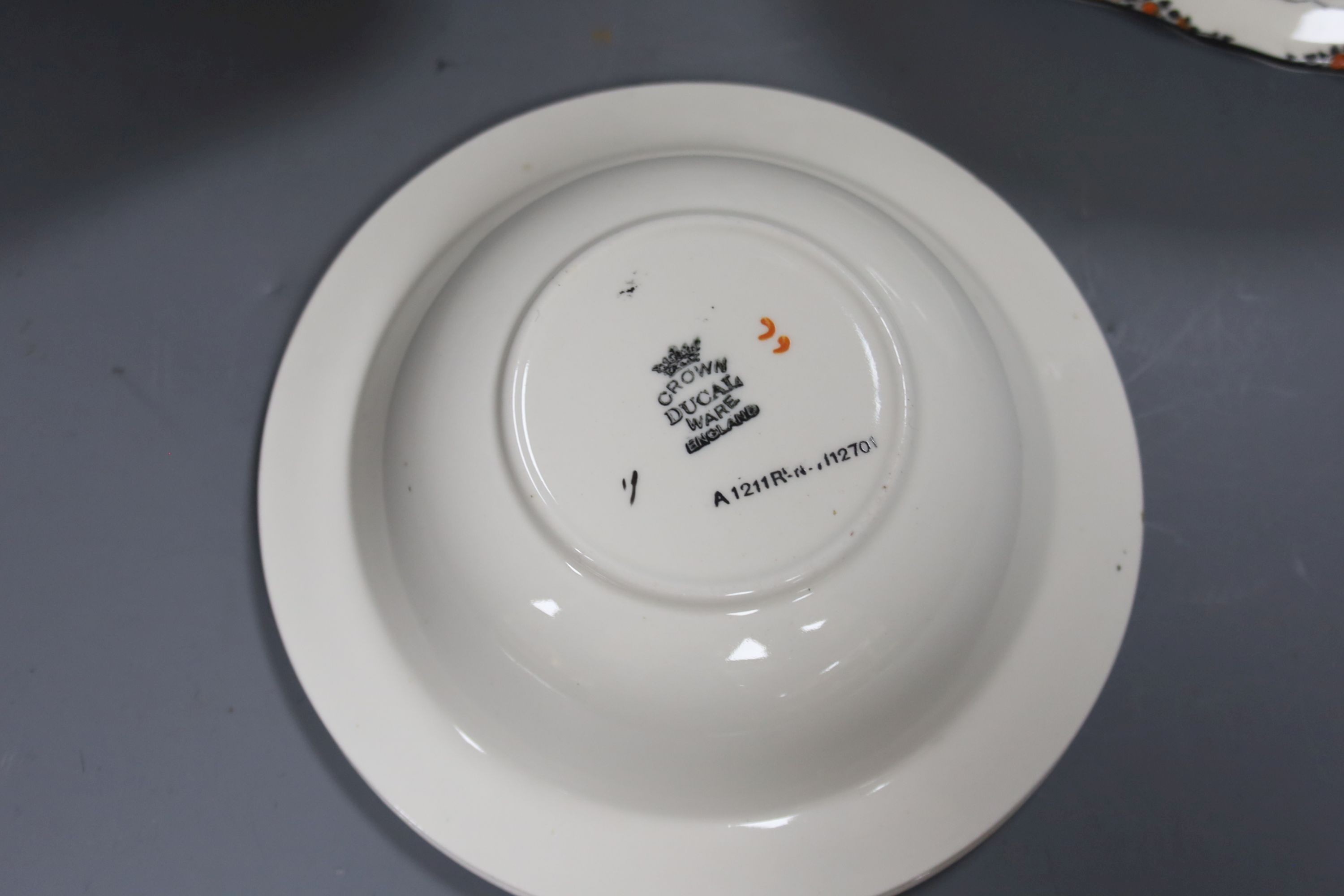A Crown Ducal Art Deco 'Orange Tree' breakfast, tea and coffee service, to include a biscuit barrel, cheese dish and toast rack